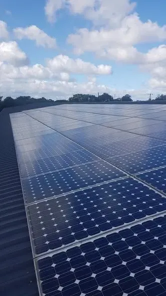 Clean solar panel array on a commercial roof in North Wales after inspection