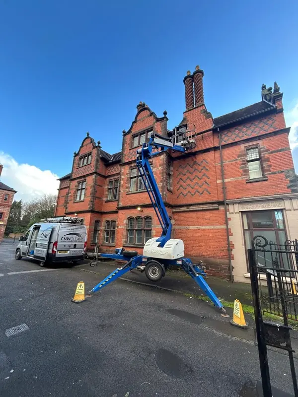 Cherry picker hire in Chester, access platform set up beside a Victorian red brick building