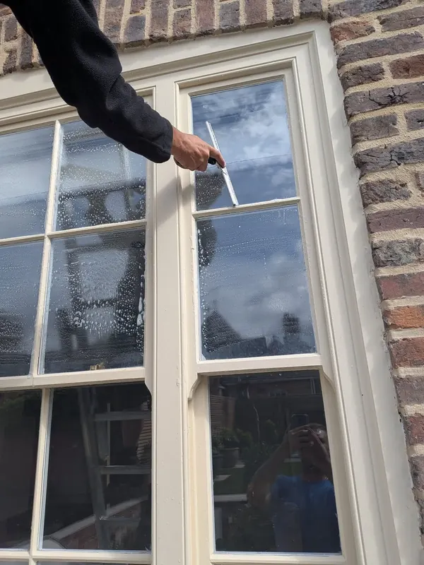 Hand cleaning sash windows on a domestic property in Chester