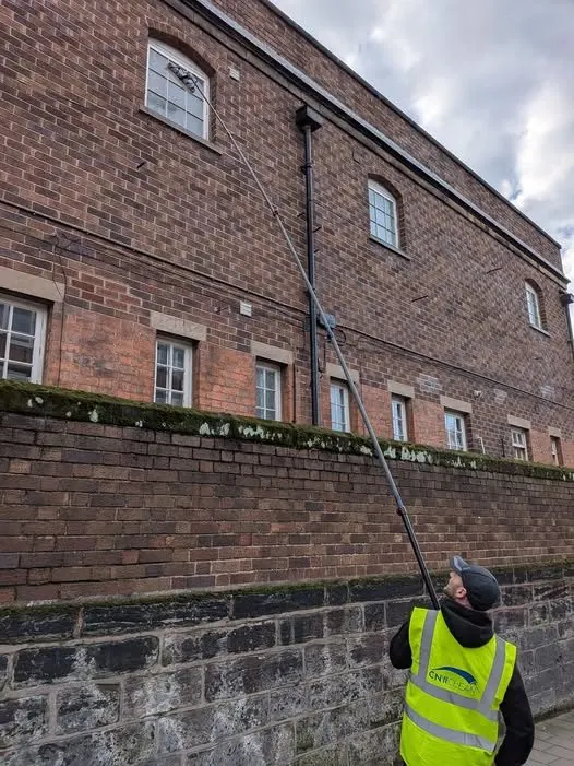 Commercial window cleaning on an upper-floor brick building in Chester